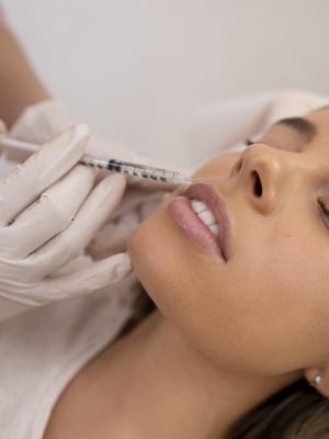 close-up-woman-getting-lip-filler-with-injection